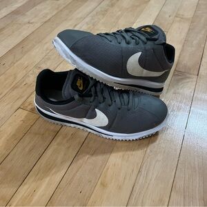 Nike Dark Gray Sneakers with White and Gold Accents
